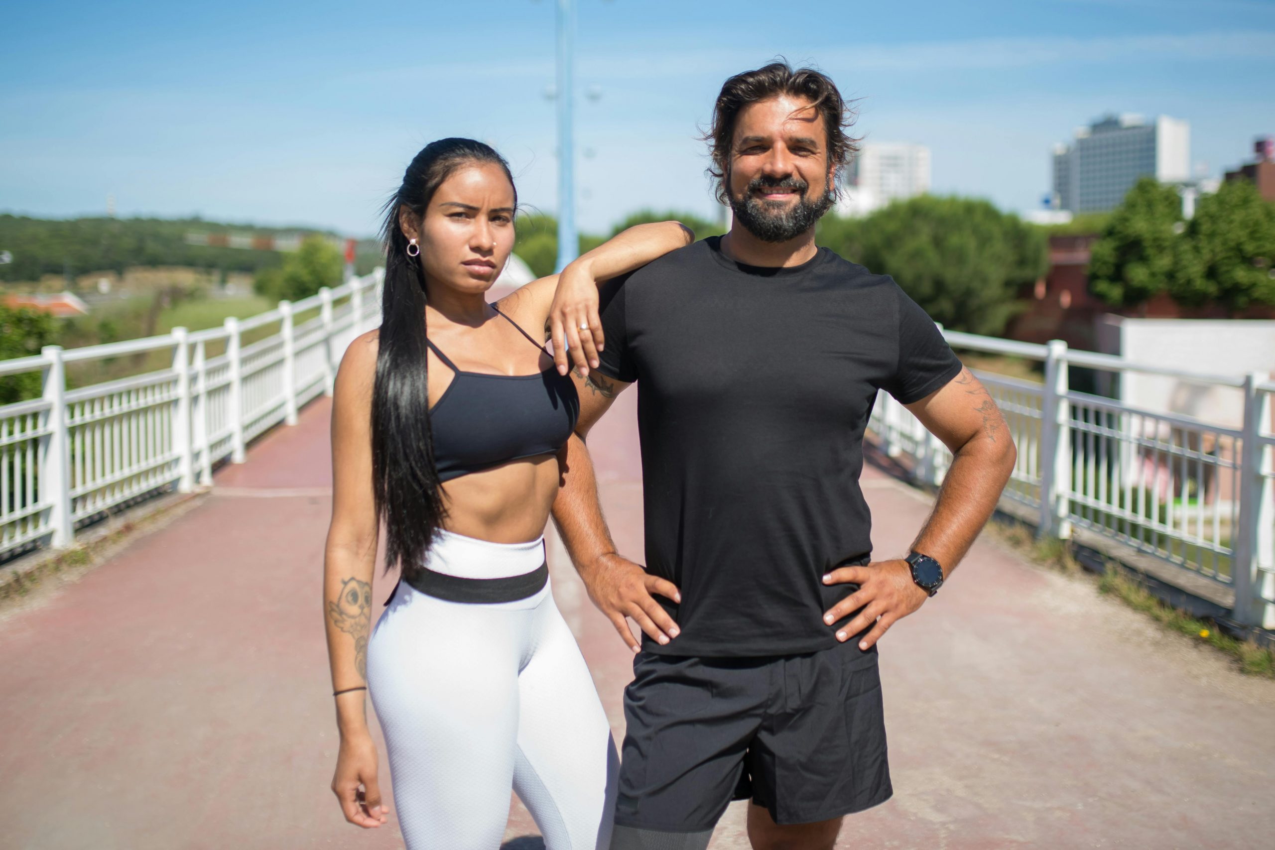 fit couple in activewear standing confidently